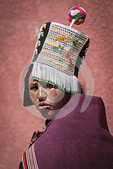 Unidentified indigenous native Quechua woman with traditional tribal clothing and hat, at the Tarabuco Sunday Market, Bolivia